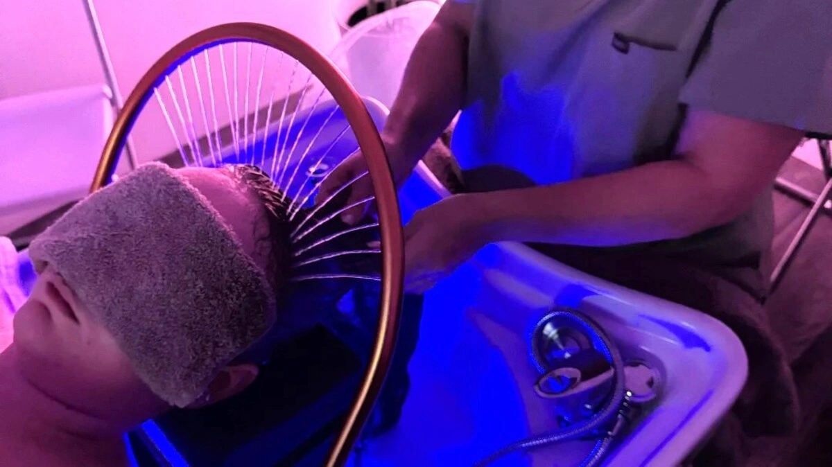 Top view of a therapist washing a client’s hair during a Japanese head spa treatment