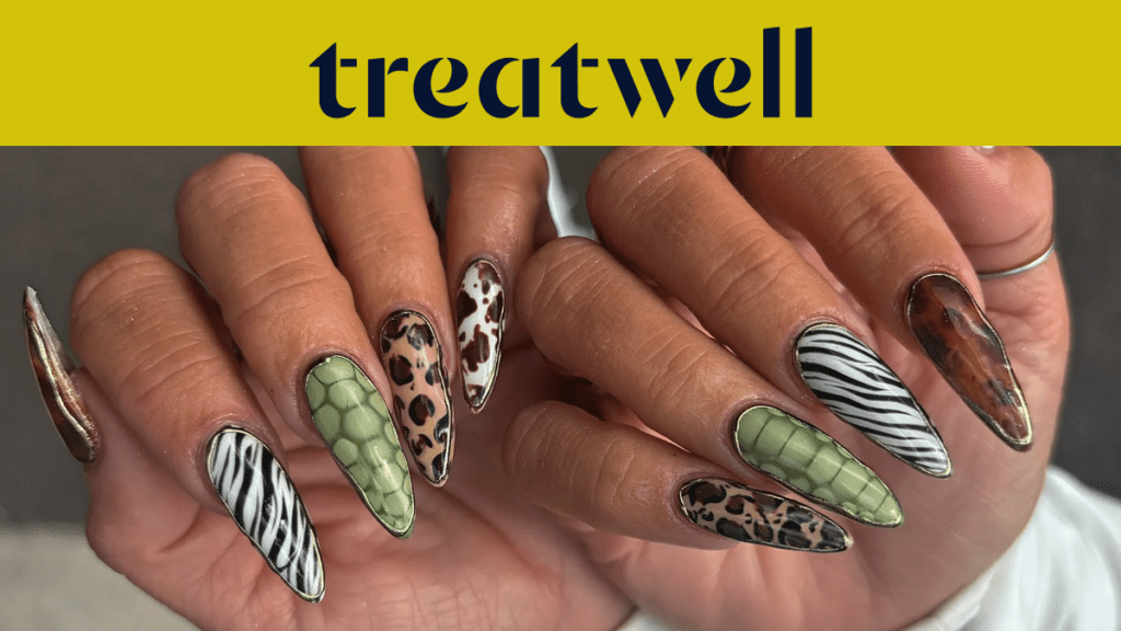 Two hands showing off long almond-shaped nails in assorted animal prints, including zebra stripes, leopard spots, green snakeskin and tortoiseshell.