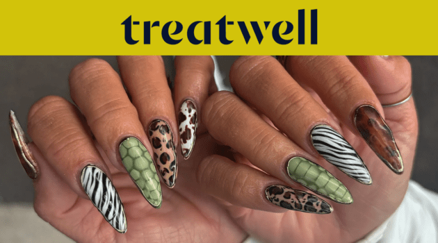 Two hands showing off long almond-shaped nails in assorted animal prints, including zebra stripes, leopard spots, green snakeskin and tortoiseshell.