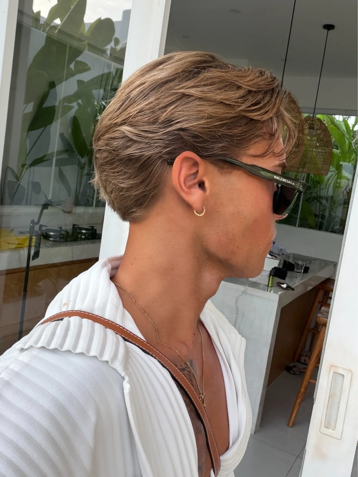 Side profile of a textured European flow hairstyle with swept-back layers and natural movement