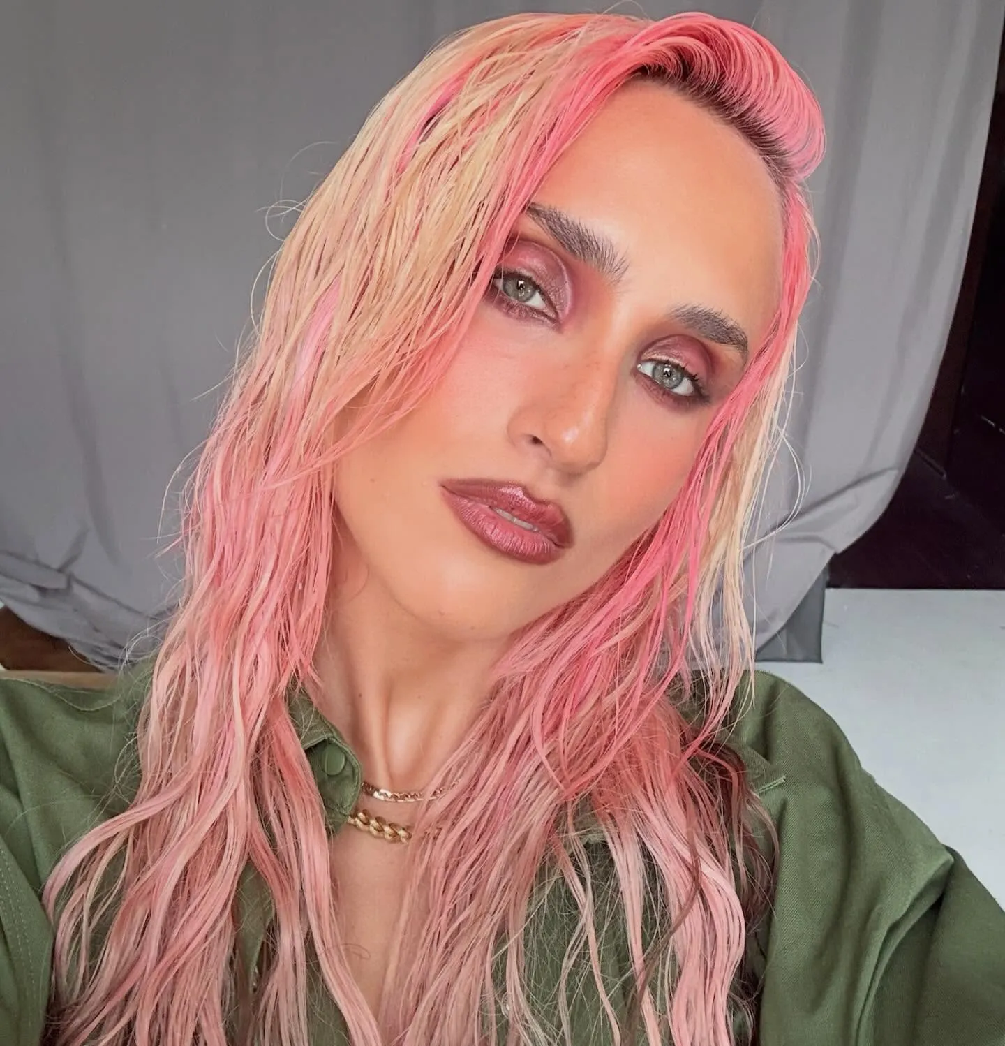 Long wavy pink hair with peach and blonde tones, textured wet-look styling, editorial summer portrait